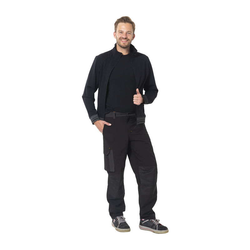 Model trägt die schwarze Planam Moto Regenhose, wasserdicht und atmungsaktiv, mit Beuteltaschen und Oberschenkeltasche für Arbeit und Wetter.
