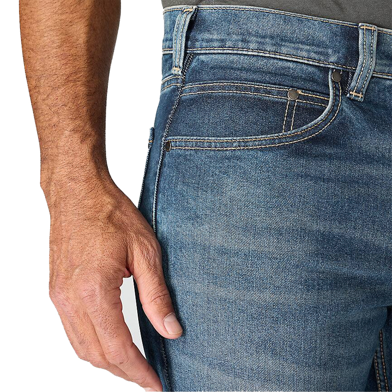Detailansicht der Carhartt 102804 Rugged Flex Stretch Jeans in Blau mit geradem Schnitt und Relaxed Fit, Fokus auf Bund und Vordertasche
